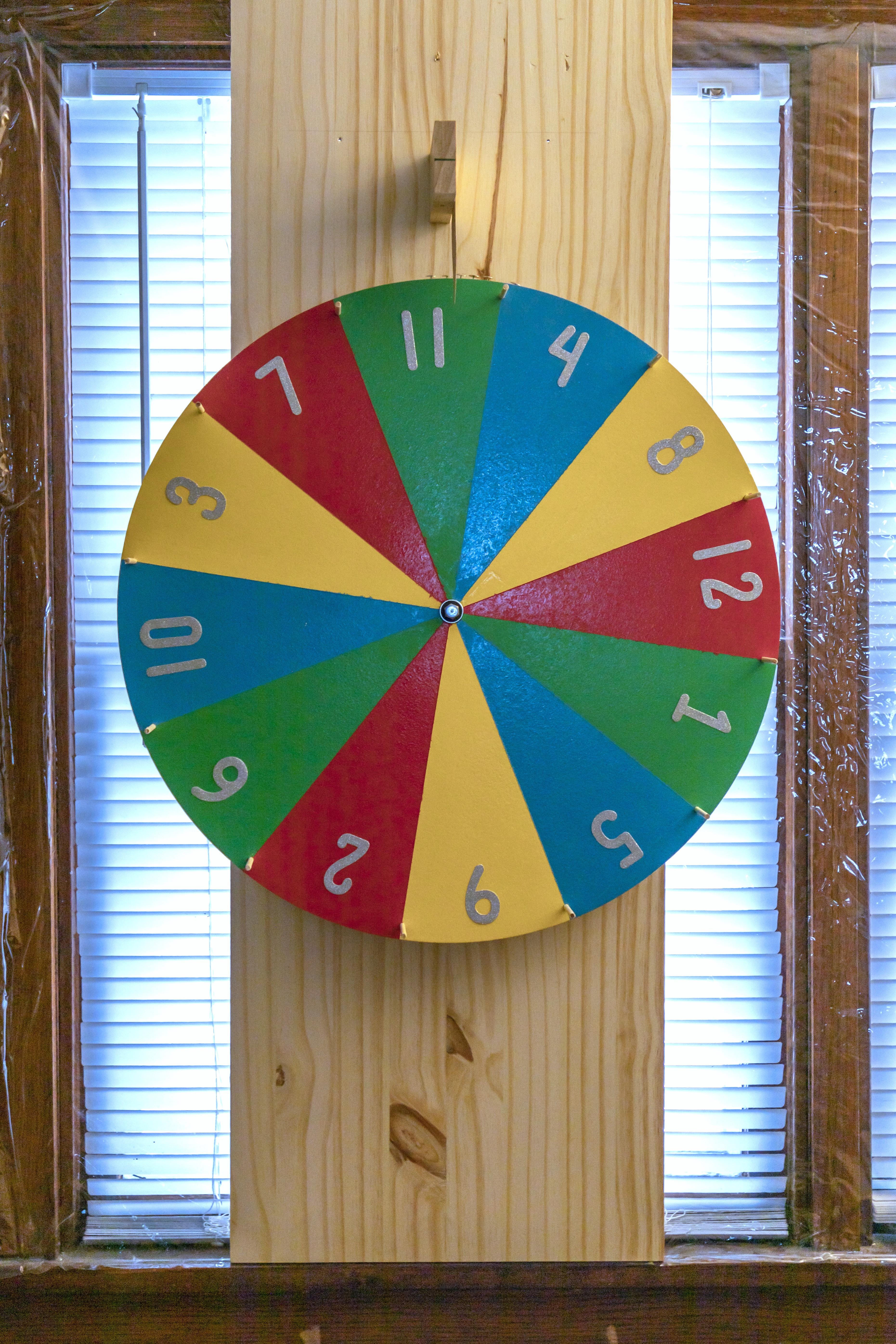 The Completely True Story of How I Ended Up Hanging a Spinning “Prize” Wheel Over My Living Room Window